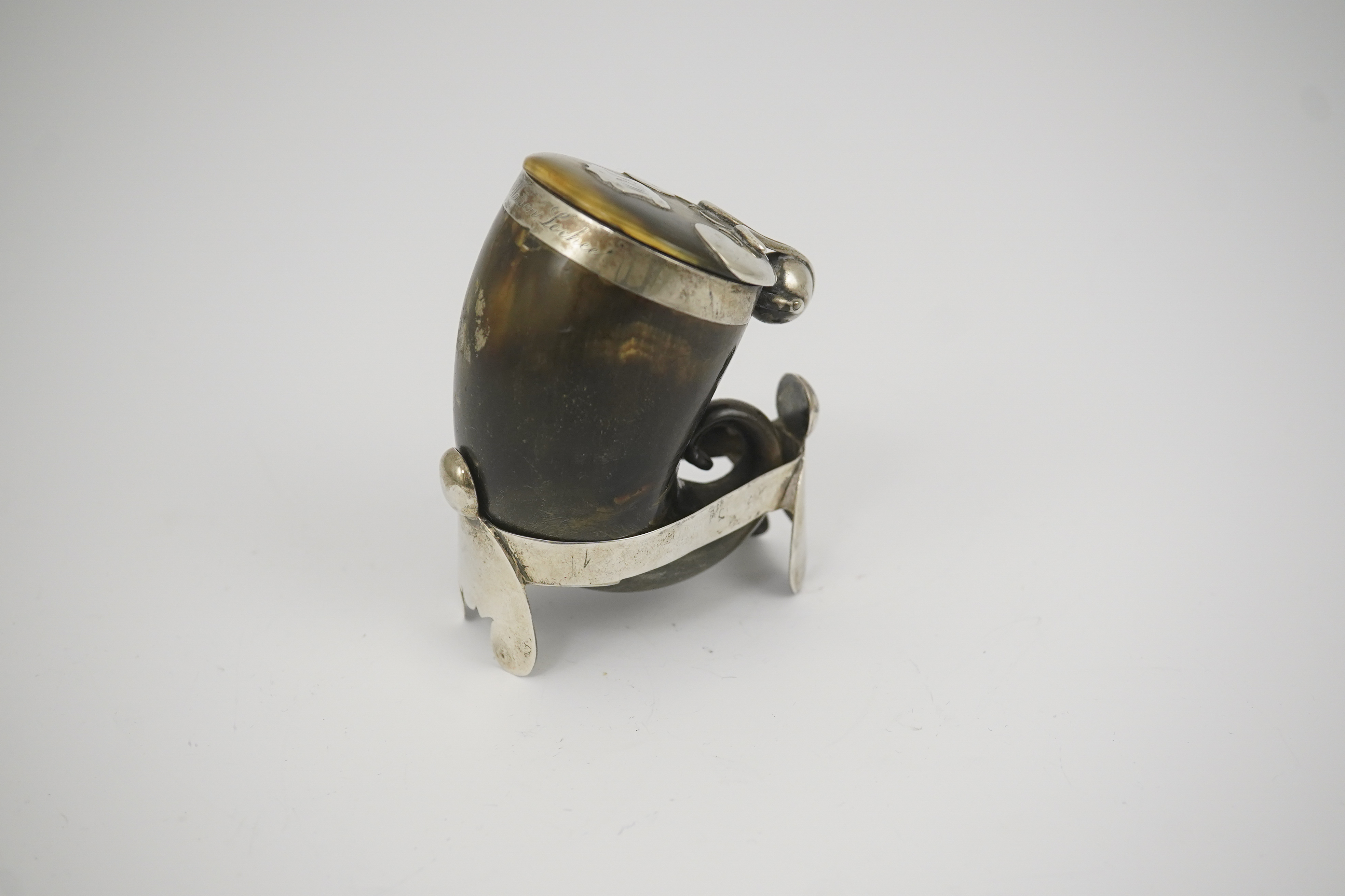 A 19th century Scottish silver mounted horn snuff mull, 7cm, on a silver stand.